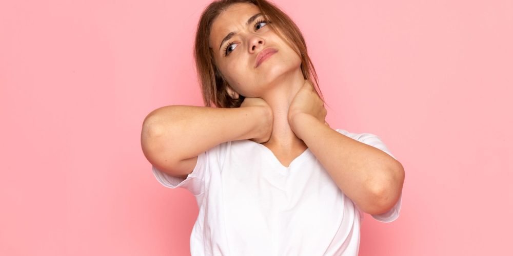 front-view-young-beautiful-female-in-white-shirt-having-neckache